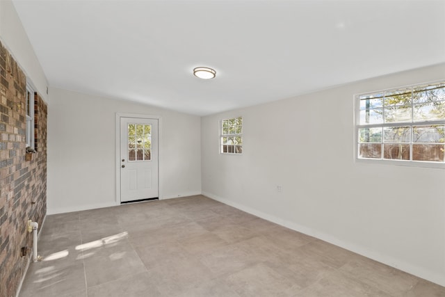 spare room featuring lofted ceiling