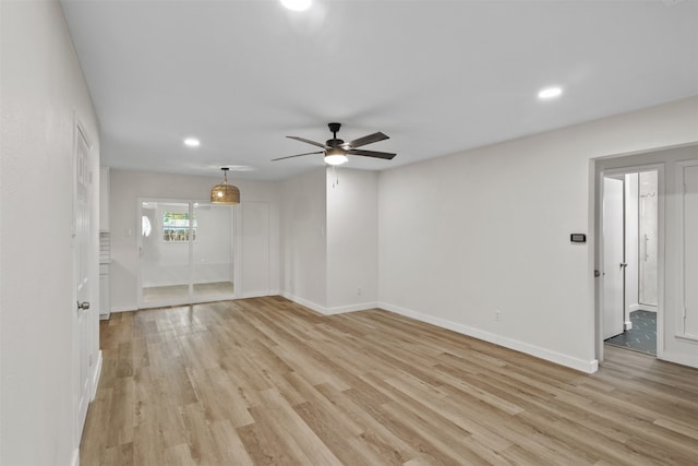 spare room with ceiling fan and light hardwood / wood-style floors