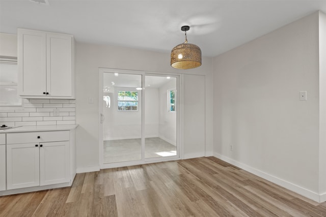 unfurnished dining area with light wood-type flooring