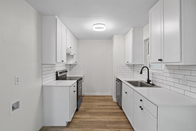 kitchen featuring light wood-type flooring, stainless steel appliances, white cabinetry, and sink