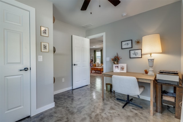 home office with concrete floors and ceiling fan