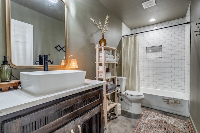 full bathroom with vanity, shower / tub combo, and toilet