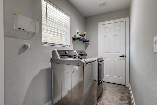 washroom with washing machine and clothes dryer