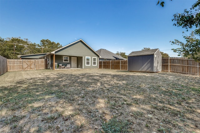 rear view of house featuring a shed, a patio area, and a yard