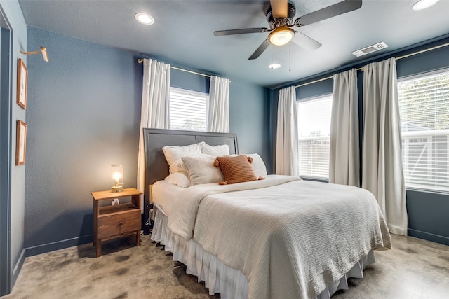 bedroom with ceiling fan, multiple windows, and light colored carpet