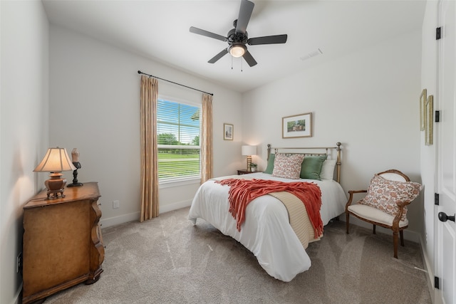 bedroom featuring ceiling fan and light carpet