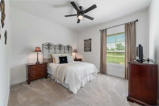 bedroom featuring ceiling fan and light carpet