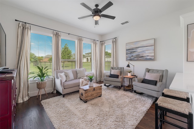 sitting room featuring dark hardwood / wood-style floors, a healthy amount of sunlight, and ceiling fan