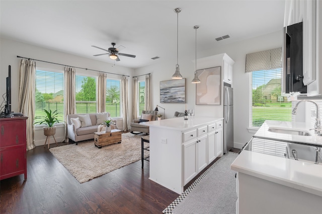 kitchen featuring dark hardwood / wood-style flooring, sink, white cabinets, and plenty of natural light