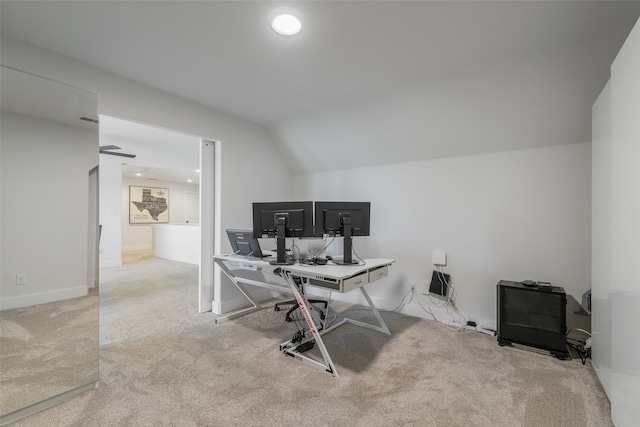 carpeted office with lofted ceiling