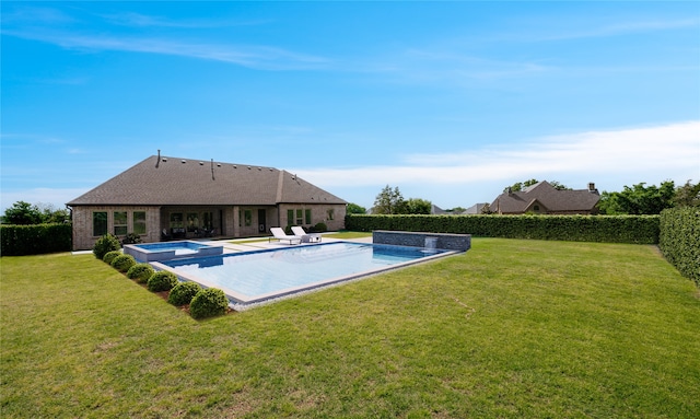 view of swimming pool with an in ground hot tub and a yard