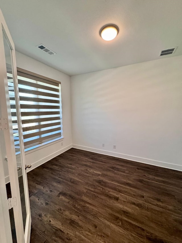 spare room featuring dark hardwood / wood-style floors