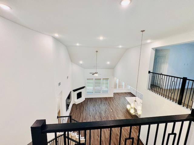 living room with lofted ceiling, ceiling fan, and dark hardwood / wood-style flooring