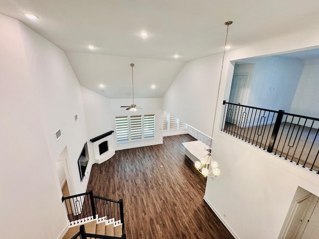 living room with lofted ceiling, dark wood-type flooring, and ceiling fan