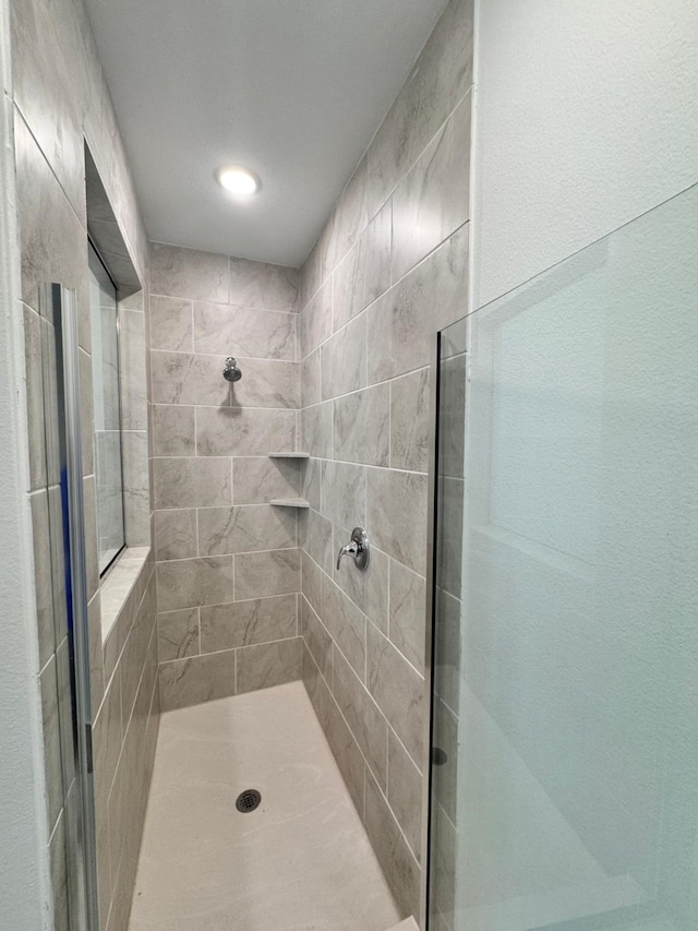 bathroom with tiled shower