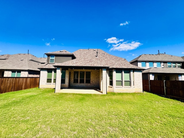 rear view of property with a patio and a lawn