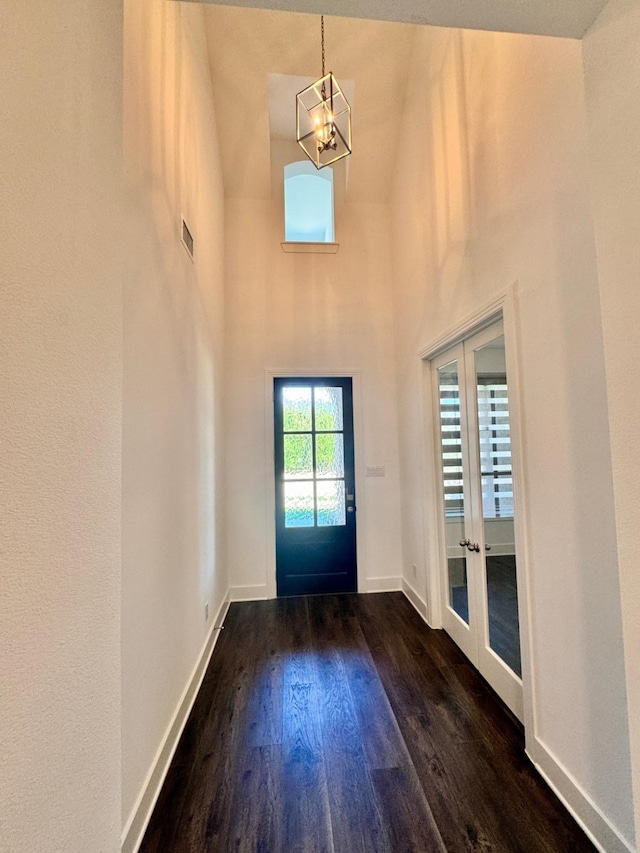 foyer featuring a high ceiling, dark hardwood / wood-style floors, and french doors