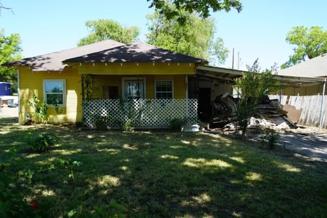 rear view of property with a lawn