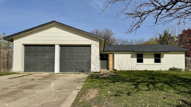 single story home featuring a garage and a front lawn