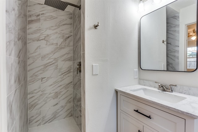 bathroom featuring vanity and a tile shower