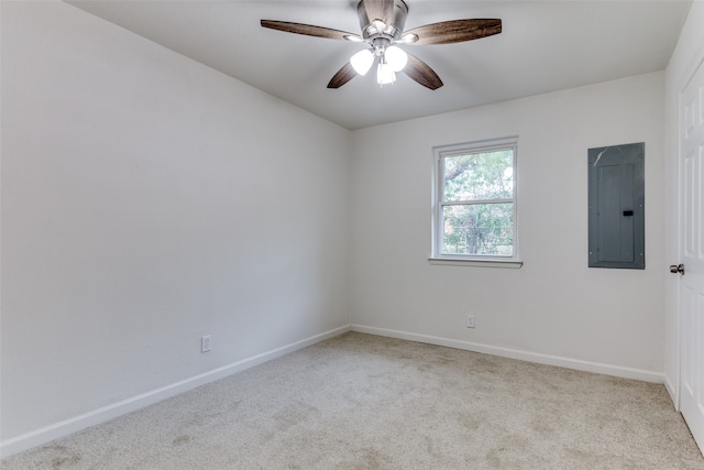 unfurnished room with ceiling fan, light colored carpet, and electric panel