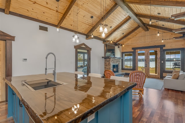 kitchen featuring wood ceiling, sink, decorative light fixtures, and blue cabinetry