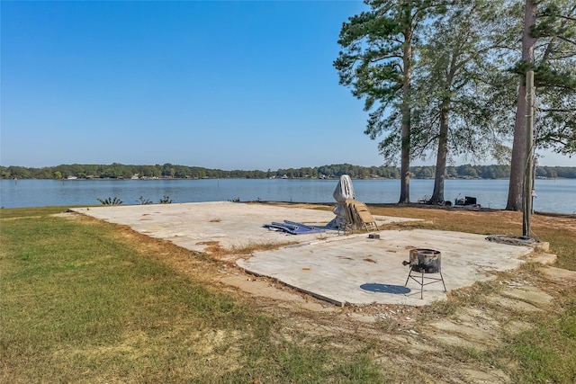 exterior space featuring a water view and an outdoor fire pit