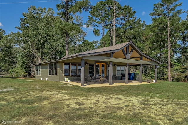 back of property with french doors, a yard, and a patio area