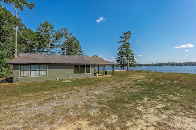 exterior space with a water view and a yard