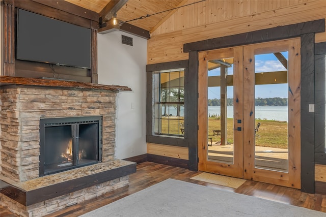 entryway featuring lofted ceiling, a wealth of natural light, dark hardwood / wood-style floors, and a water view