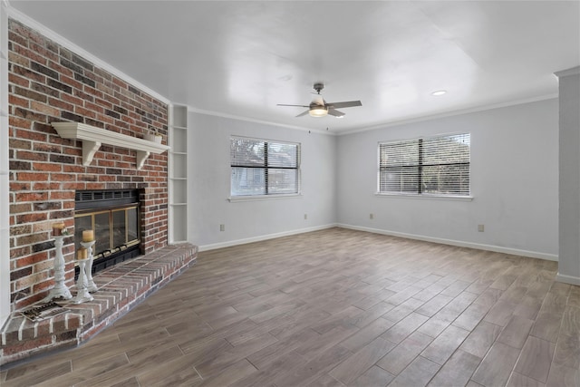 unfurnished living room featuring ornamental molding, a fireplace, wood-type flooring, and ceiling fan