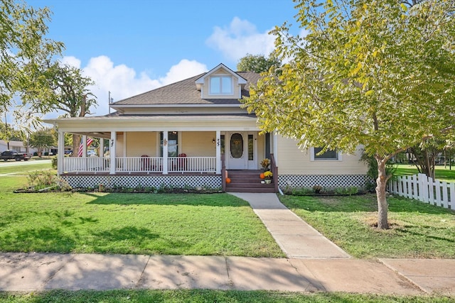 farmhouse inspired home with a front yard and a porch