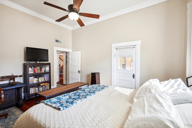 bedroom featuring dark wood-type flooring, ceiling fan, and ornamental molding