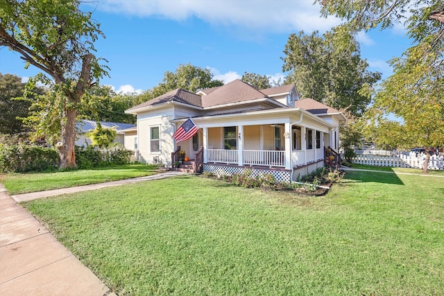 view of front facade with a front yard and covered porch