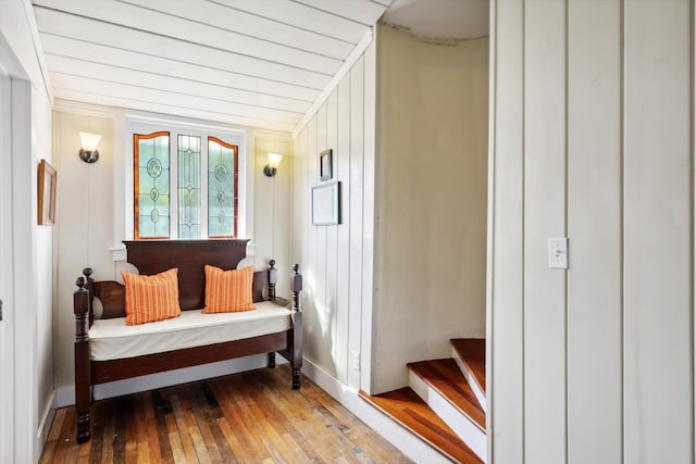 sitting room with wooden walls and hardwood / wood-style flooring