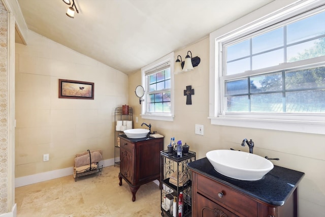 bathroom featuring vanity and lofted ceiling