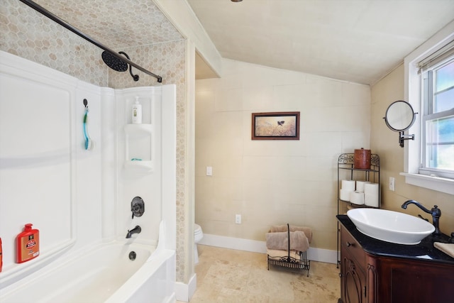 full bathroom with vanity, toilet, vaulted ceiling, and shower / bathtub combination