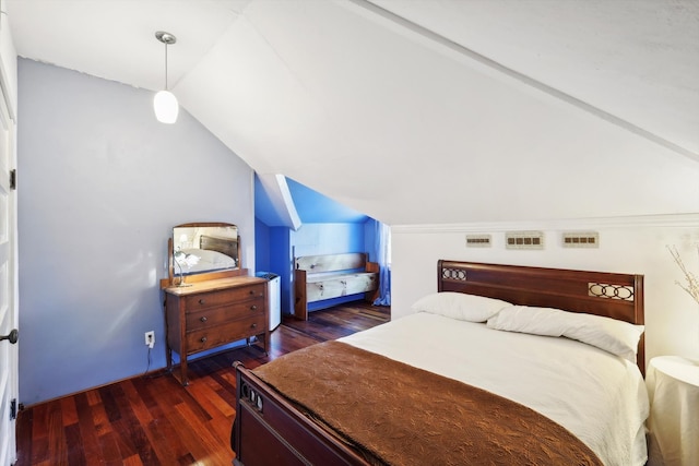 bedroom featuring lofted ceiling and dark hardwood / wood-style floors