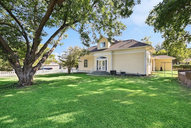 rear view of property with a lawn