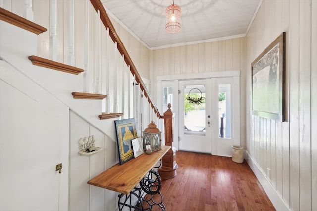 entrance foyer with ornamental molding and wood-type flooring