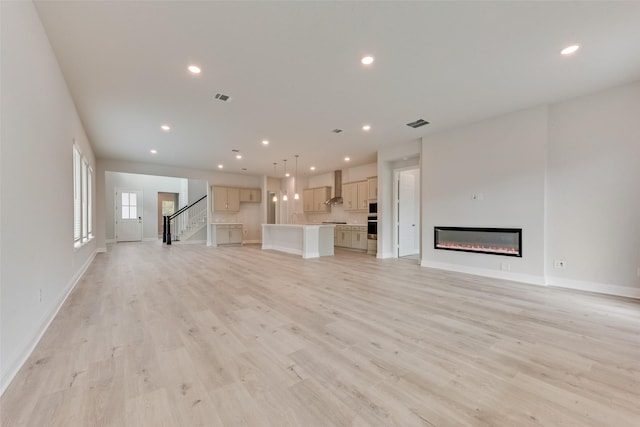 unfurnished living room with light hardwood / wood-style flooring