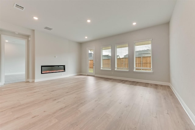 unfurnished living room with light hardwood / wood-style flooring