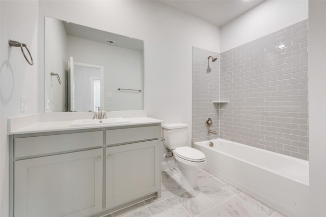 full bathroom with vanity, toilet, and tiled shower / bath