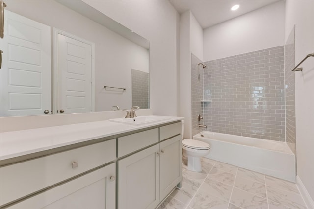 full bathroom featuring vanity, toilet, and tiled shower / bath combo