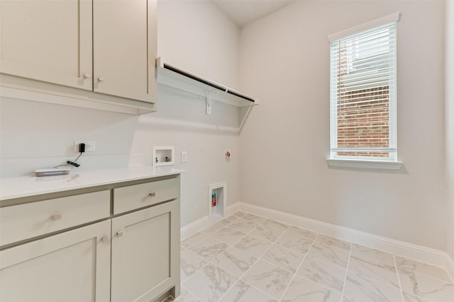 clothes washing area with a wealth of natural light, cabinets, hookup for a washing machine, and hookup for a gas dryer