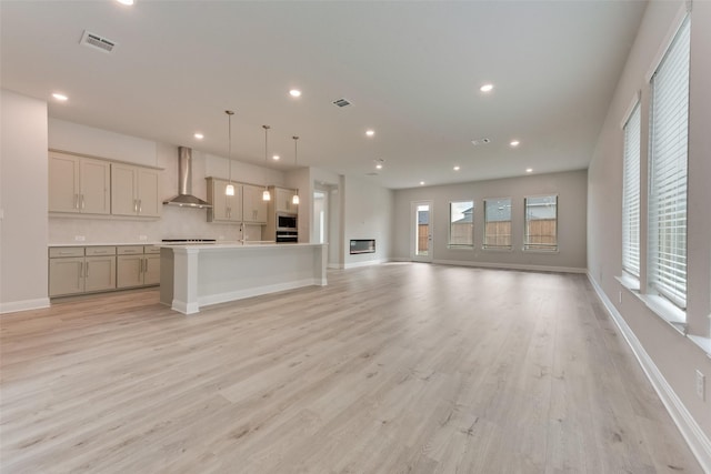 unfurnished living room featuring light hardwood / wood-style floors