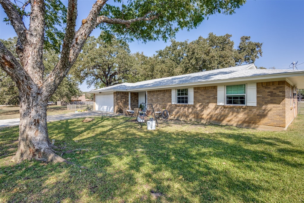 single story home with a front lawn and a garage