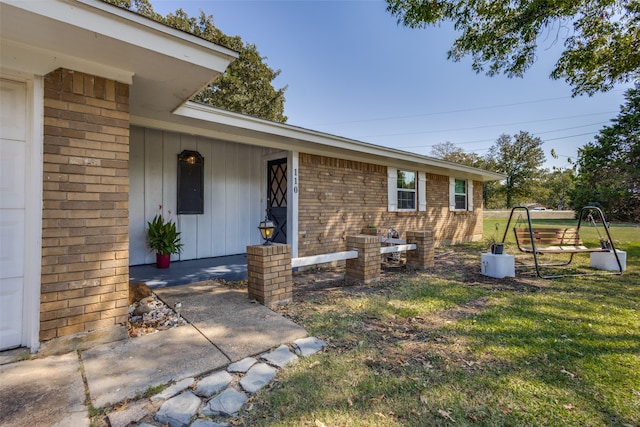 doorway to property with a yard