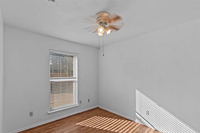 unfurnished room featuring hardwood / wood-style floors and ceiling fan