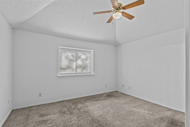 spare room with lofted ceiling, ceiling fan, a textured ceiling, and carpet flooring